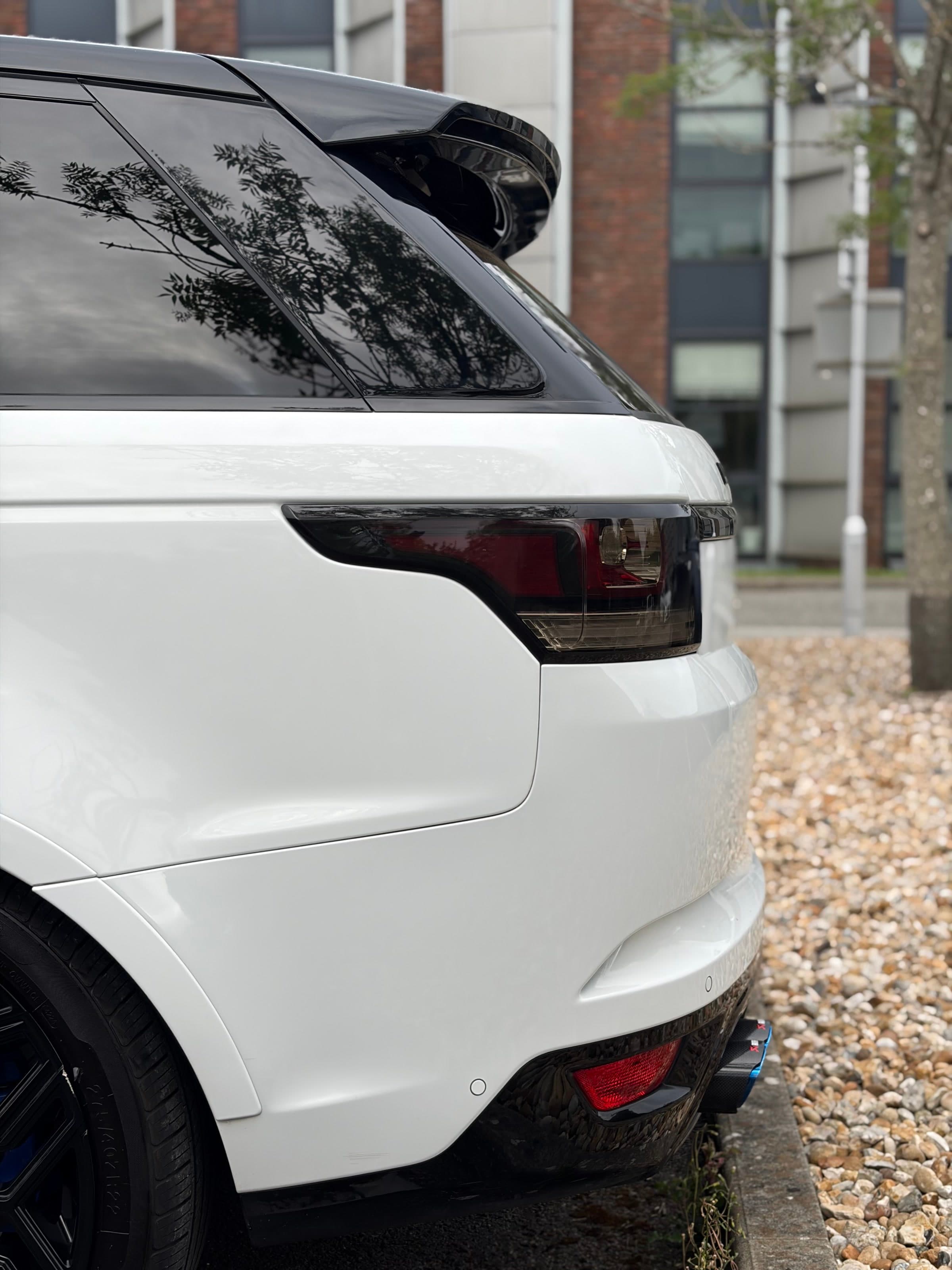 Ceramic-coated white Range Rover Sport SVR rear quarter with smoked light and gloss black wheel